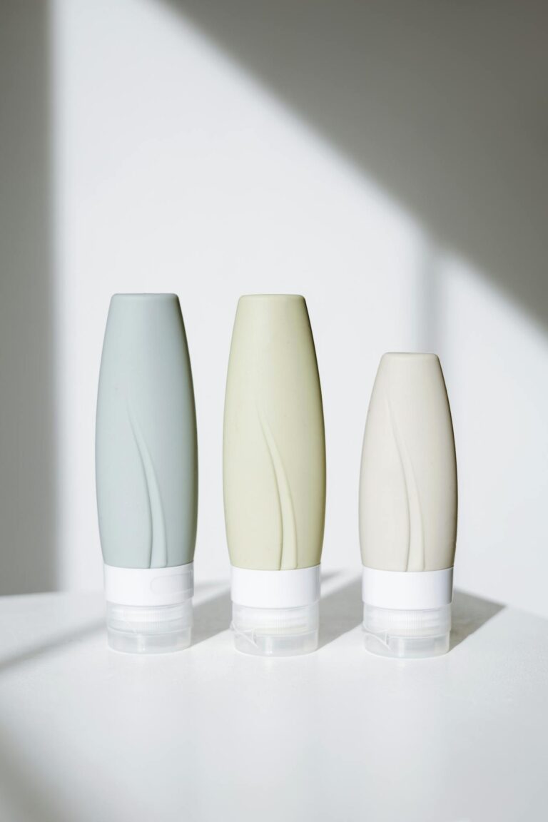 Elegant tubes of skincare products in a minimalist setup with bright lighting.